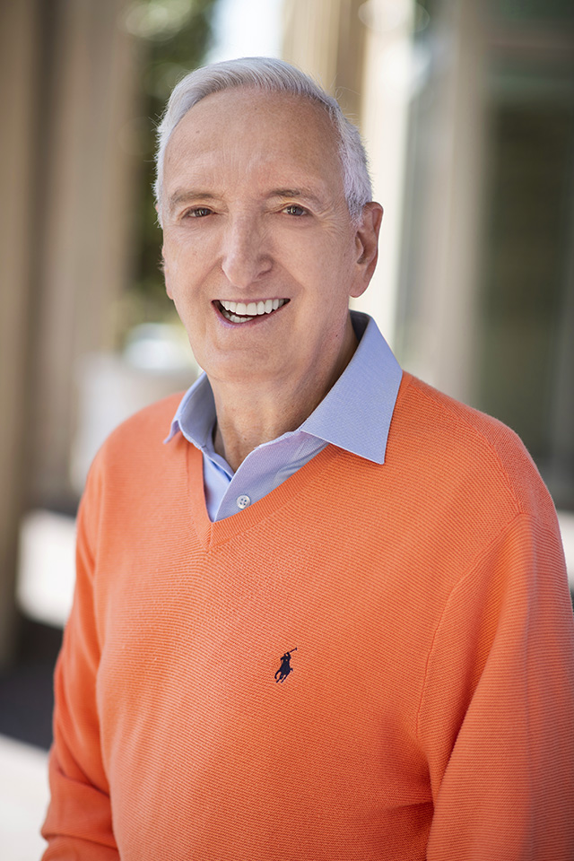 Boaz Power smiling in an orange sweater