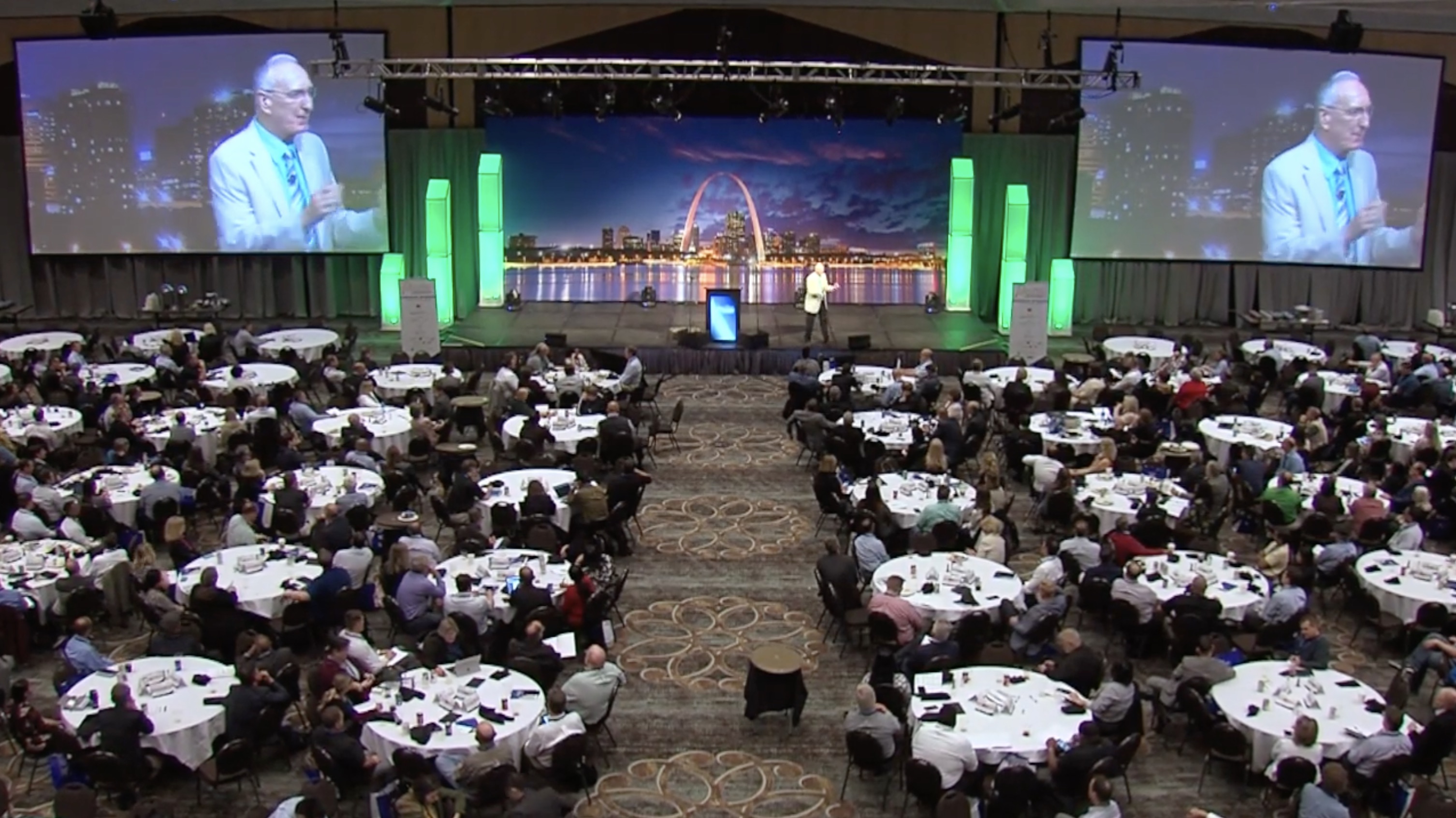 Boaz Power speaking to a large conference audience from a keynote stage